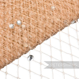 Petershams Millinery Supplies beige diamond-patterned veiling embellished with clear acrylic diamantes for millinery.