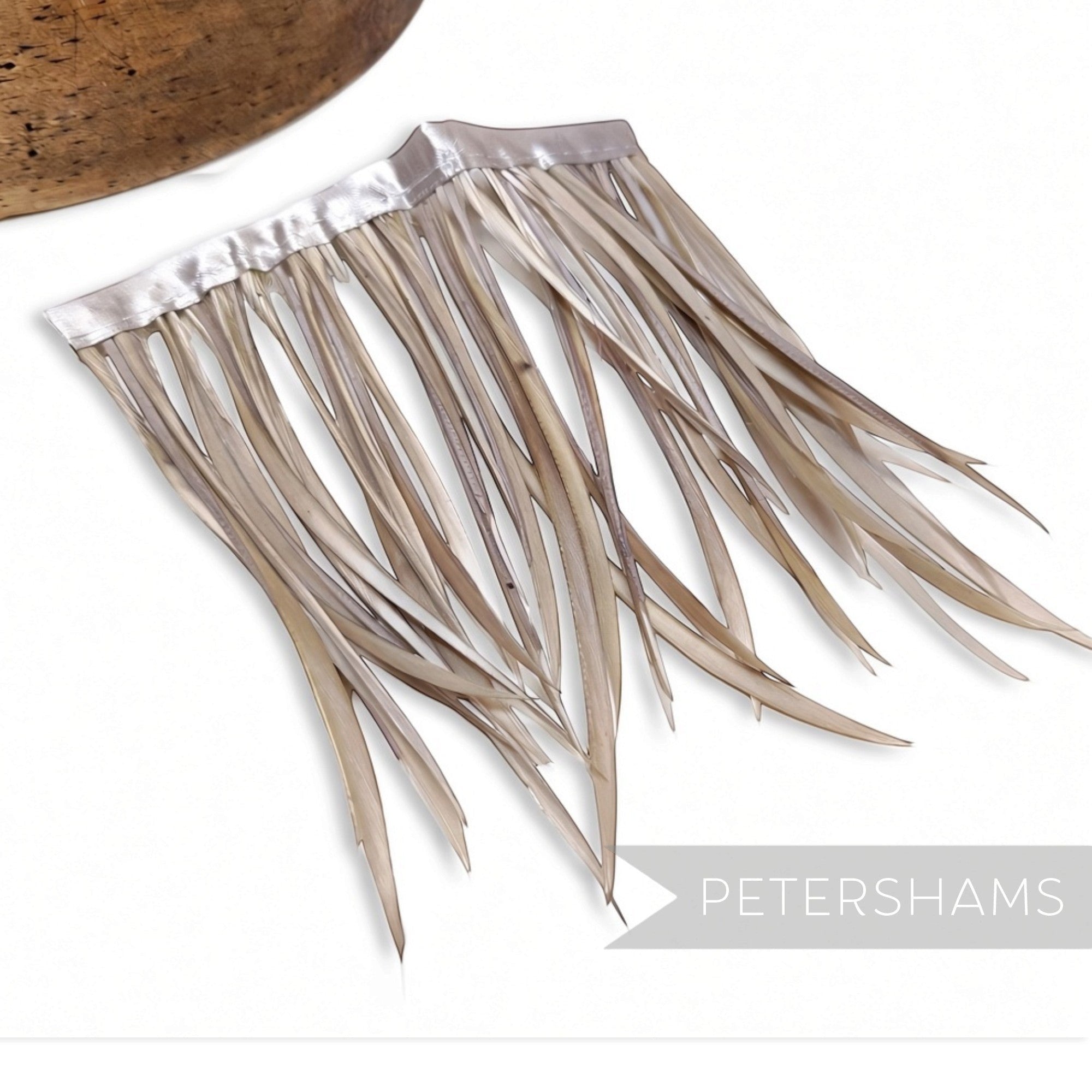 Petershams Millinery Supplies goose biot feather fringe in a neutral beige tone with a satin ribbon binding.