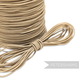 Petershams Millinery Supplies 1.2mm beige round hat elastic cord on a spool for fascinators and millinery projects.