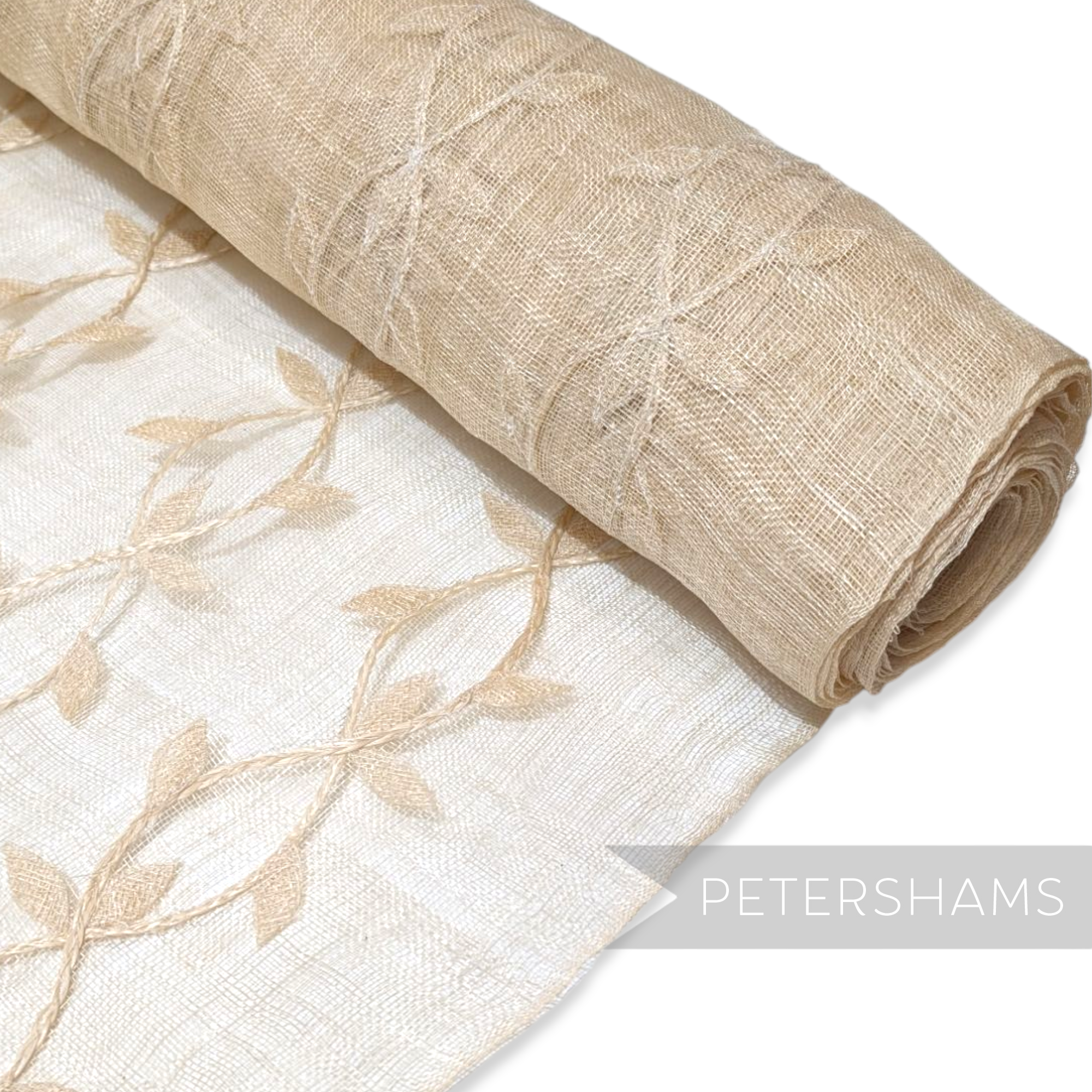 Petershams Millinery Supplies beige sinamay abaca fabric with applique leaf vine pattern on a rolled bolt.