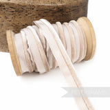 Petershams Millinery Supplies 5mm beige velvet insertion piping cord on a wooden spool for millinery and sewing.