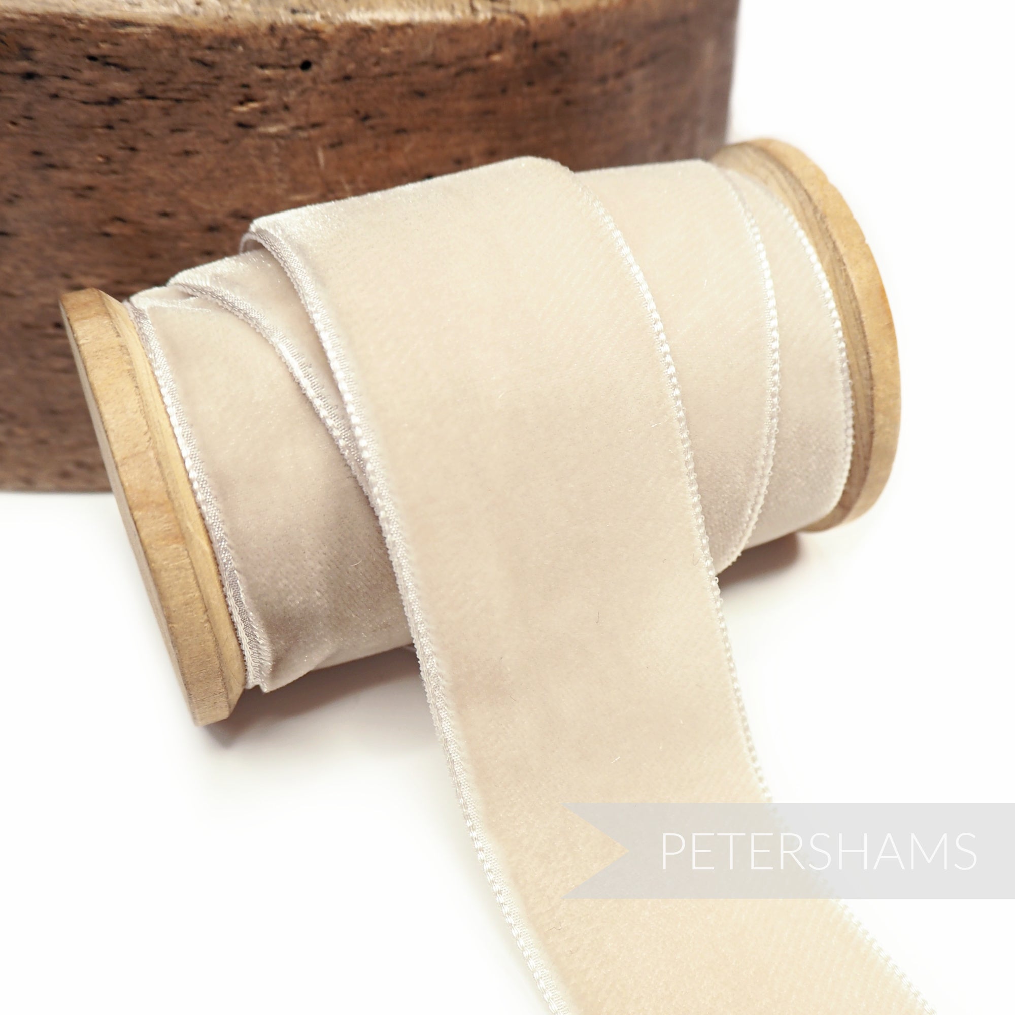 Petershams Millinery Supplies 36mm wide blonde French velvet ribbon on a wooden spool with a luxurious sheen.