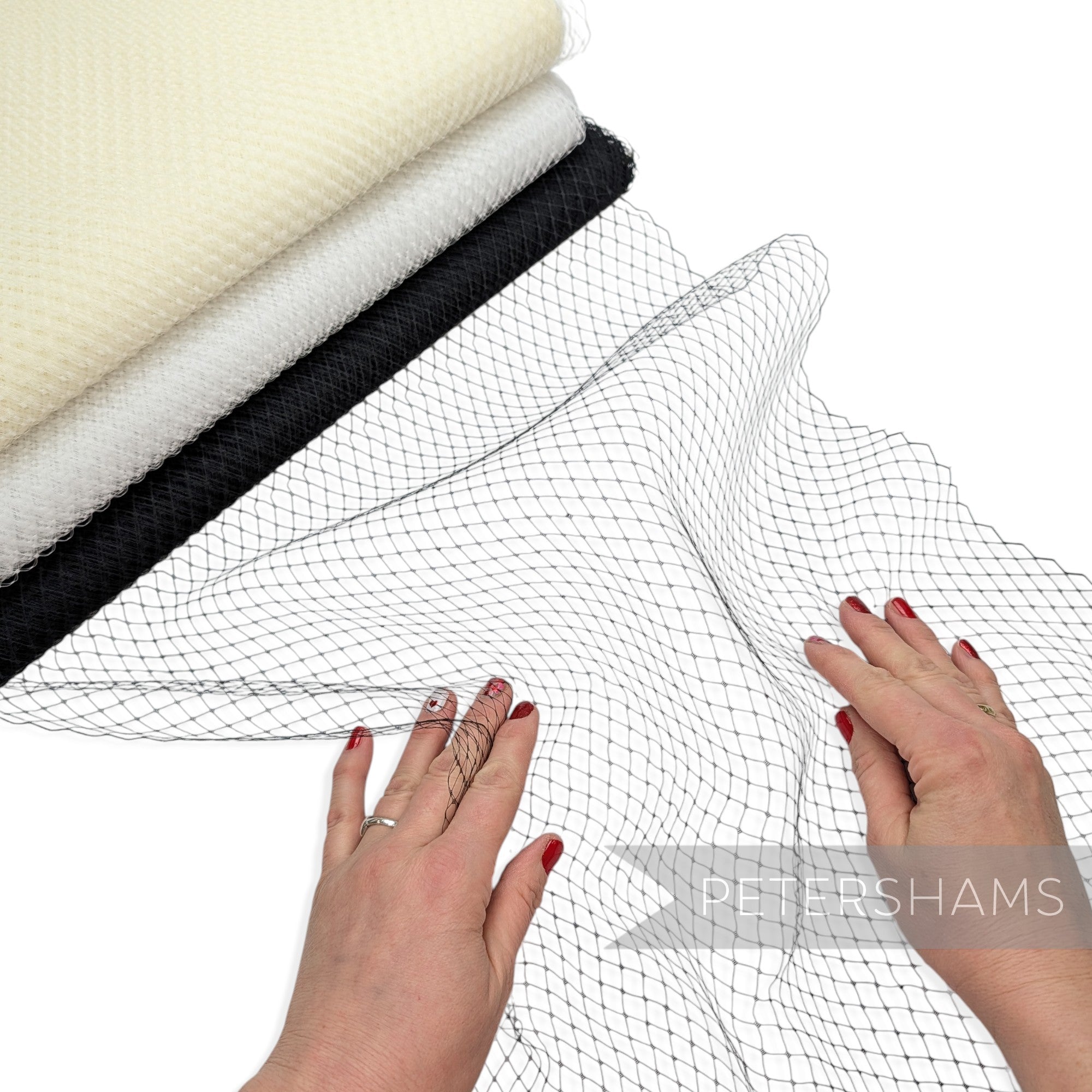 Petershams Millinery Supplies 18-inch wide diamond pattern birdcage veiling in black, white, and cream stacked rolls.
