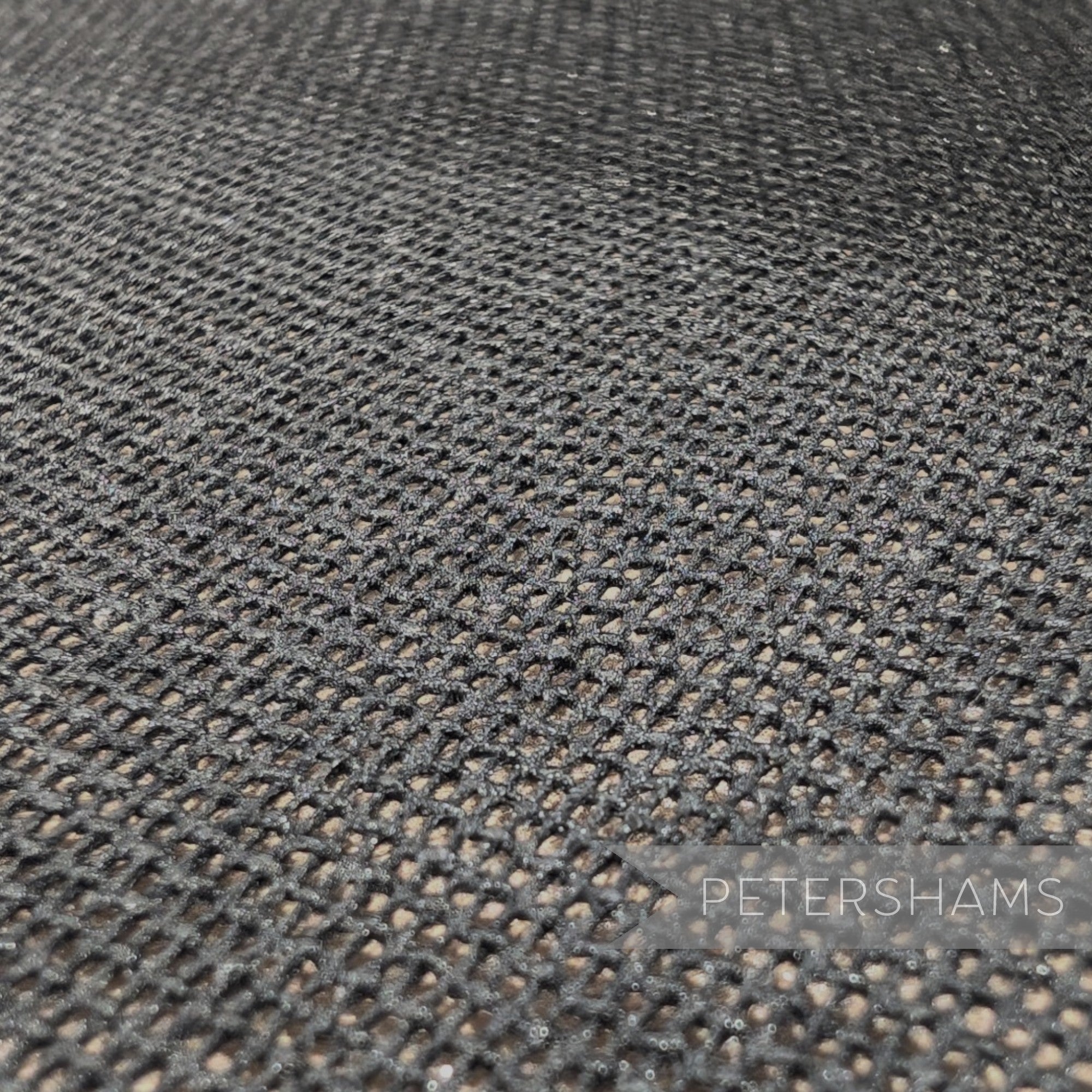 Petershams Millinery Supplies double-sided black cotton buckram fabric with a stiffened open-weave mesh texture.