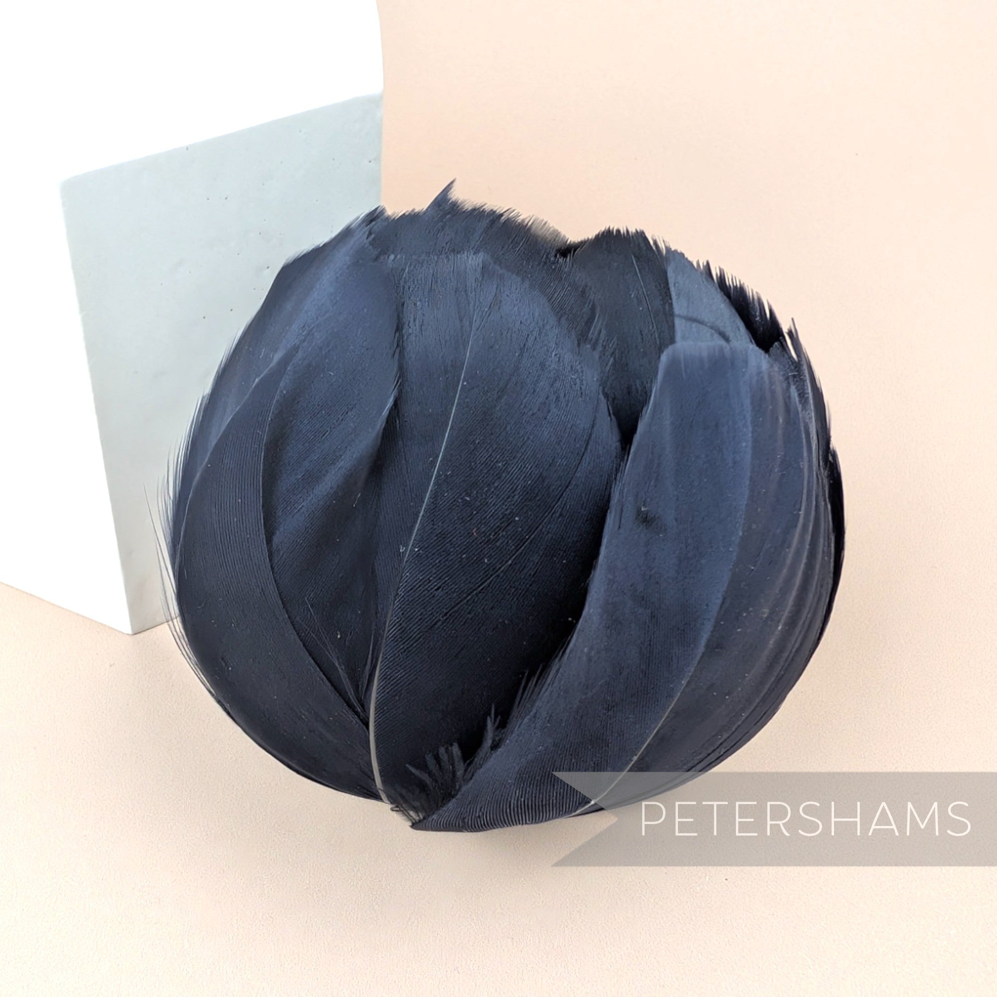Petershams Millinery Supplies large black tulip-shaped feather flower made from cupped goose nagorie feathers.