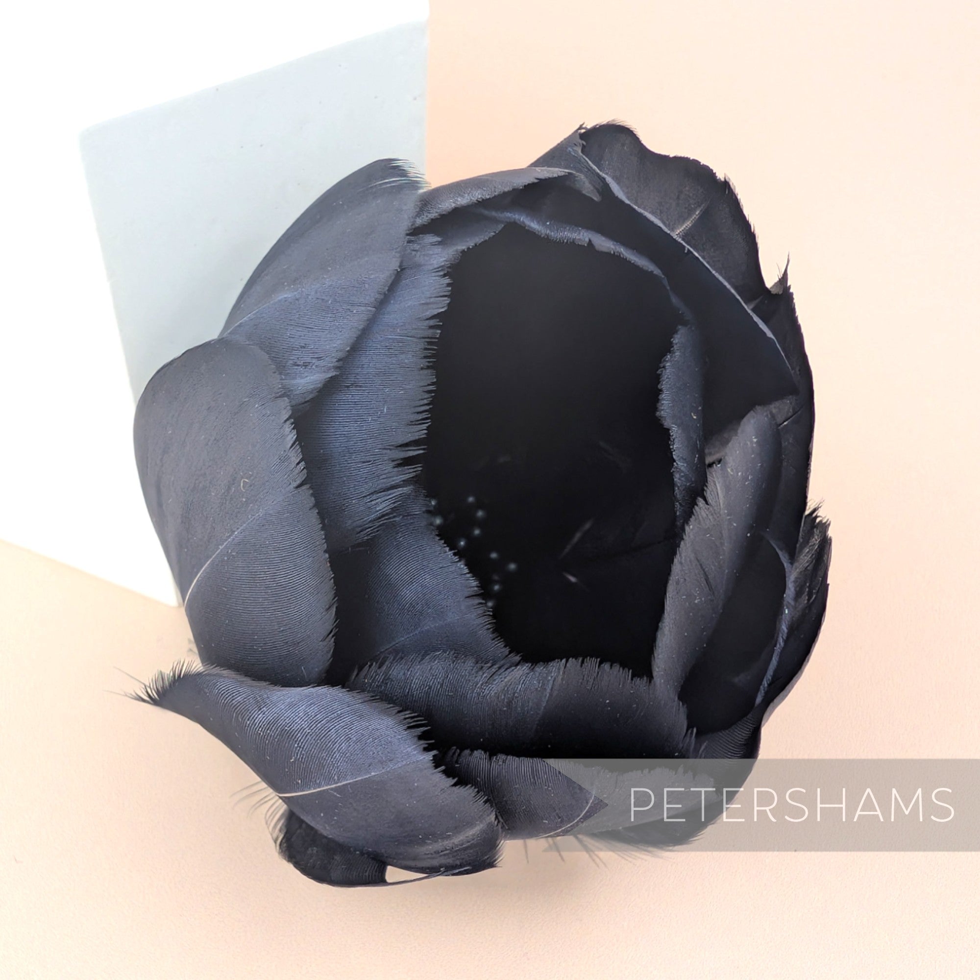 Petershams Millinery Supplies large black tulip flower made from cupped goose nagorie feathers with central stamens.