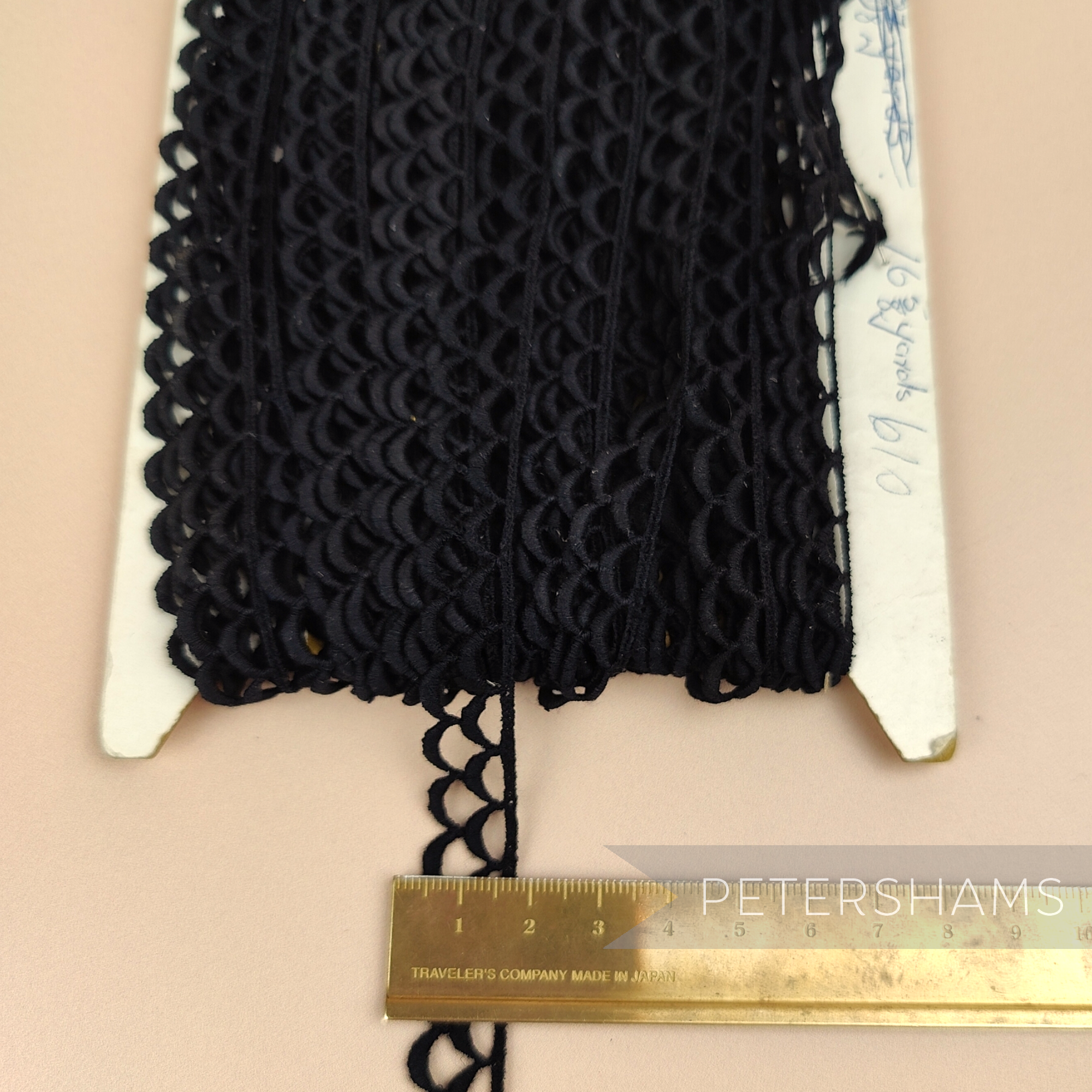 Petershams Millinery Supplies vintage 13mm black guipure lace trim with a scalloped eyelash wheel design on a card.