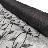 Petershams Millinery Supplies black sinamay fabric with an applique leaf vine pattern on a rolled bolt.