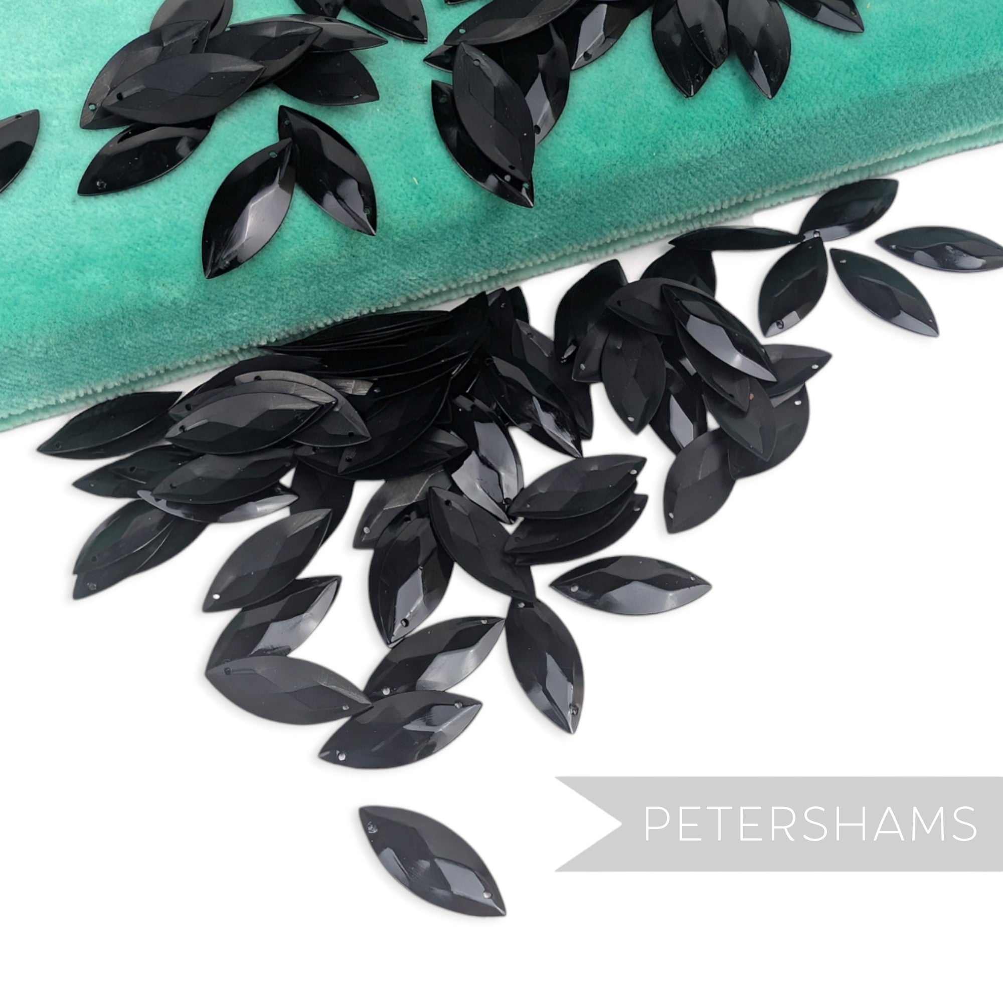 Petershams Millinery Supplies vintage black marquise jewel sequins with raised relief detail on a teal velvet box.