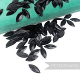 Petershams Millinery Supplies vintage black marquise jewel sequins with raised relief detail on a teal velvet box.