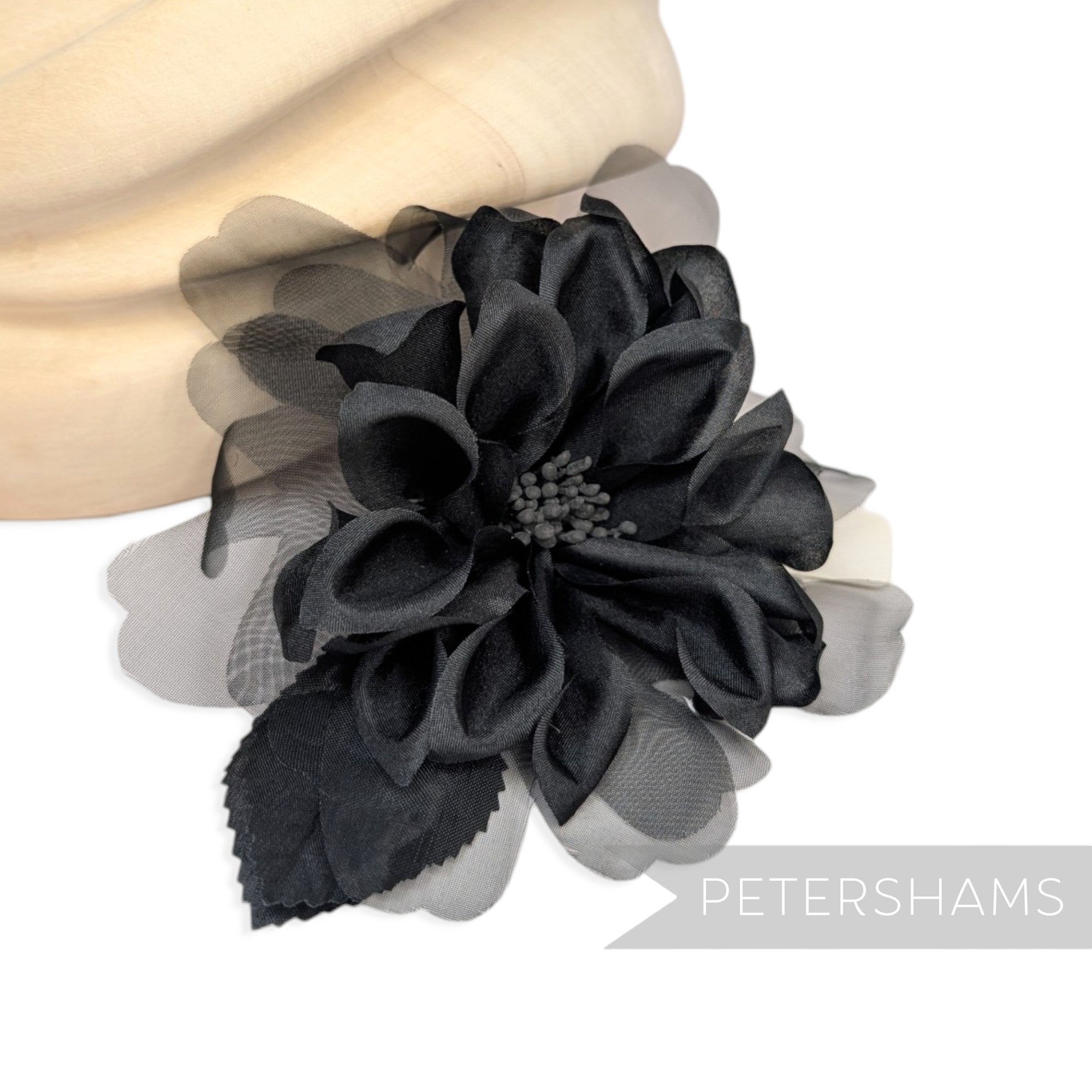Petershams Millinery Supplies black dahlia hat mount featuring layered silk and sheer organza petals with wired leaves.