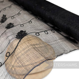 Petershams Millinery Supplies black sinamay fabric with embroidered jute vine and applique leaf details on a roll