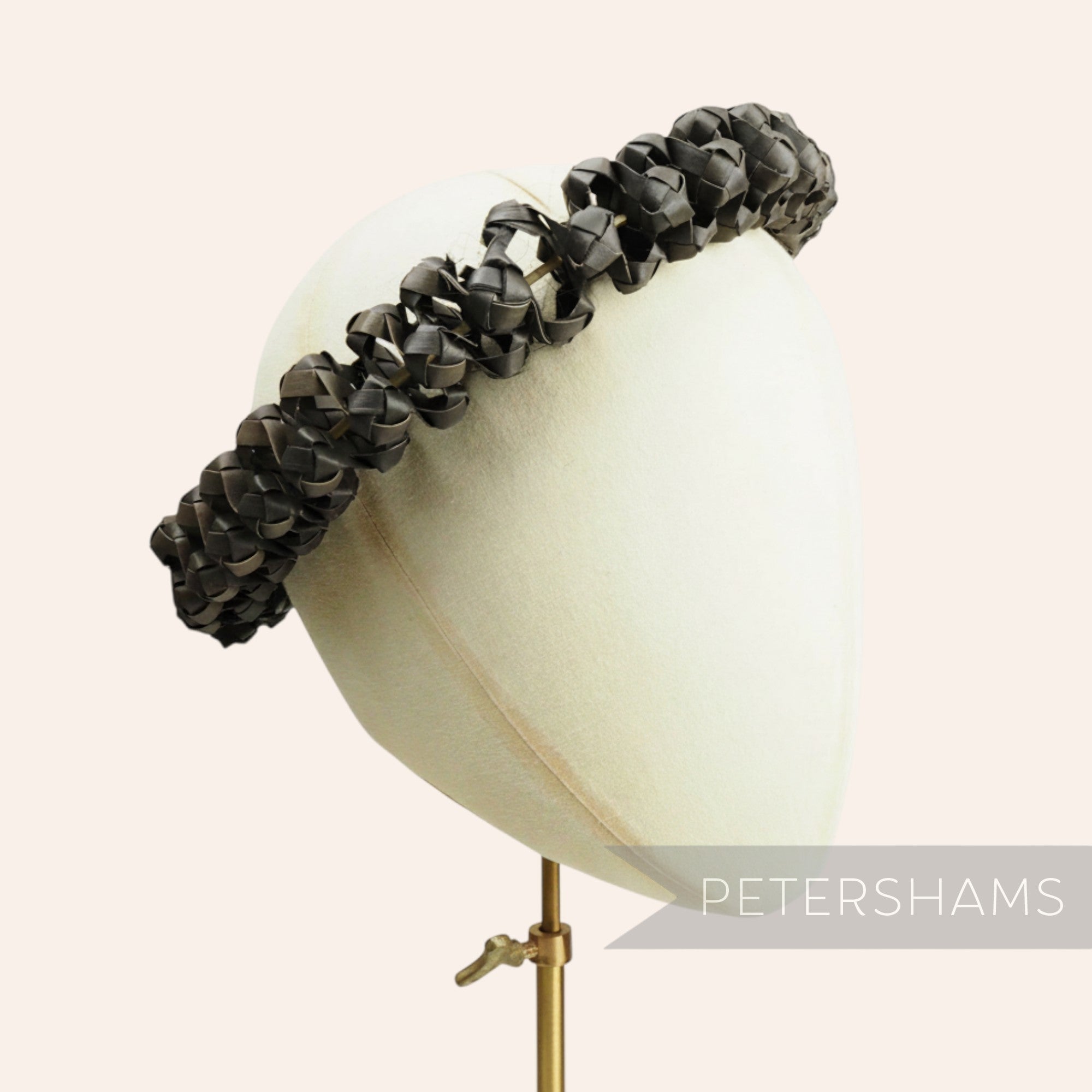 Petershams Millinery Supplies black handwoven straw adjustable headdress frame on a millinery mannequin head