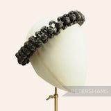 Petershams Millinery Supplies black handwoven straw adjustable headdress frame on a millinery mannequin head