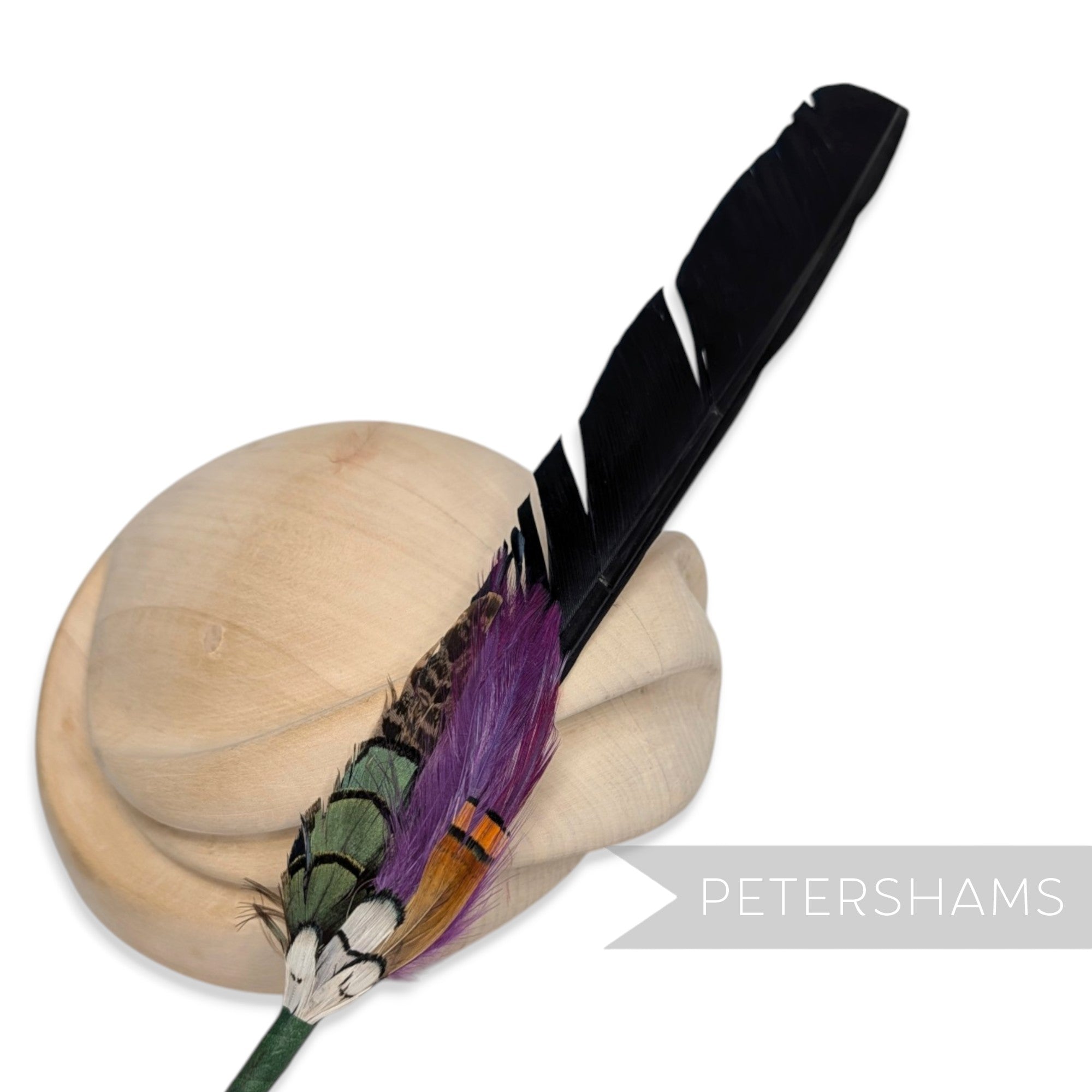 Petershams Millinery Supplies Edward extra long black turkey feather hat mount with purple and green accent feathers.