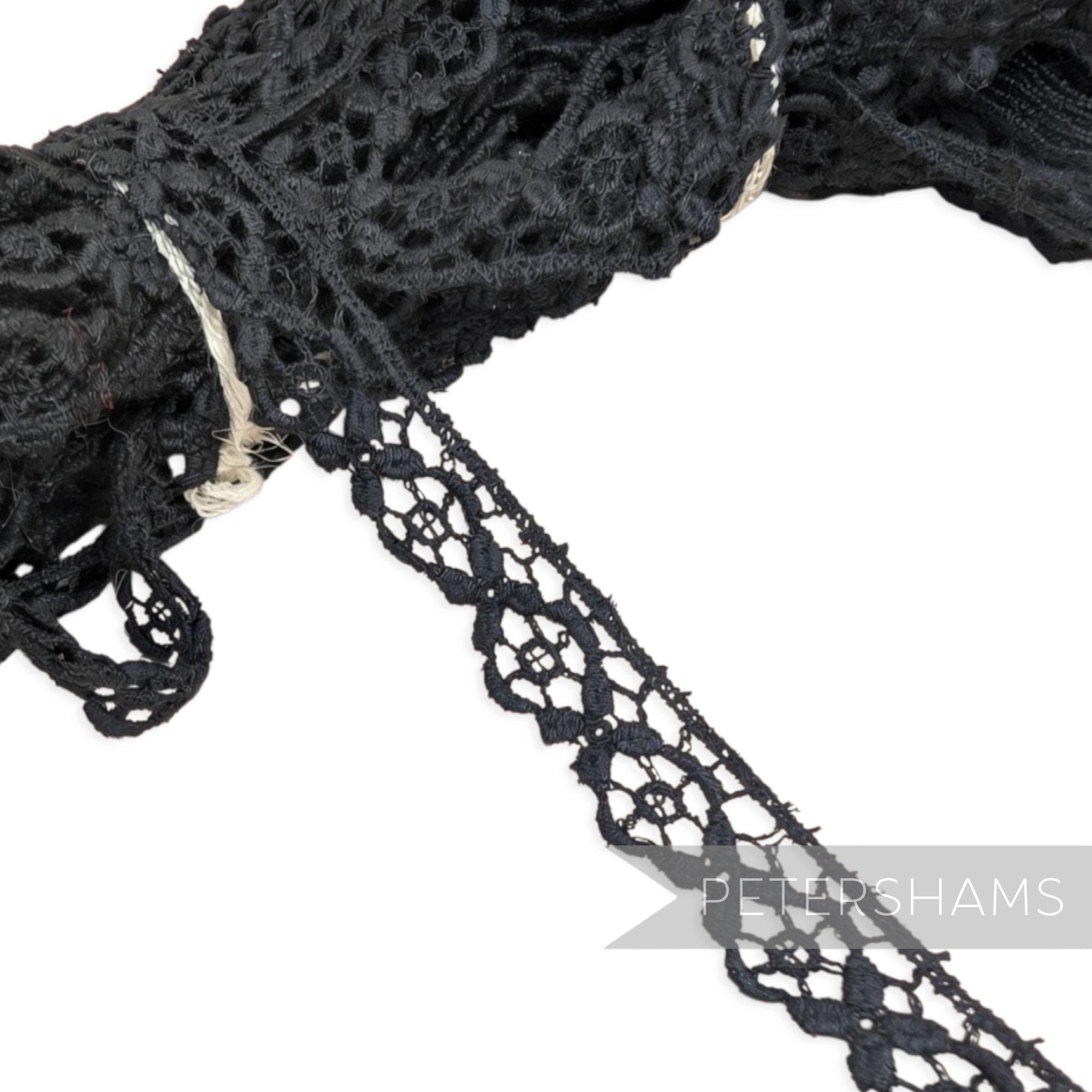 Petershams Millinery Supplies 11mm black vintage cotton guipure lace trim with a delicate floral pattern.
