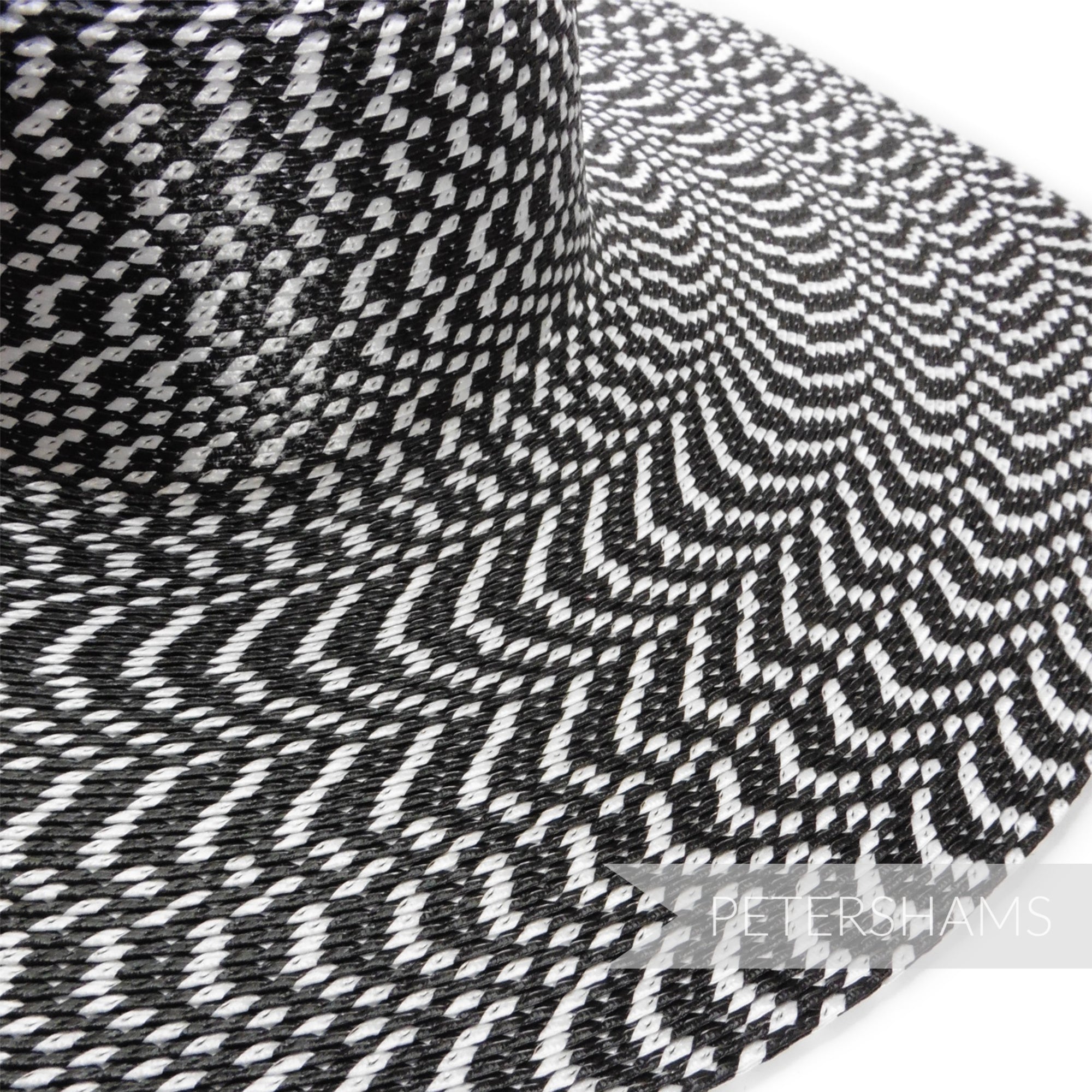 Petershams Millinery Supplies black and white polybraid capeline hat body with a hypnotic geometric pattern.