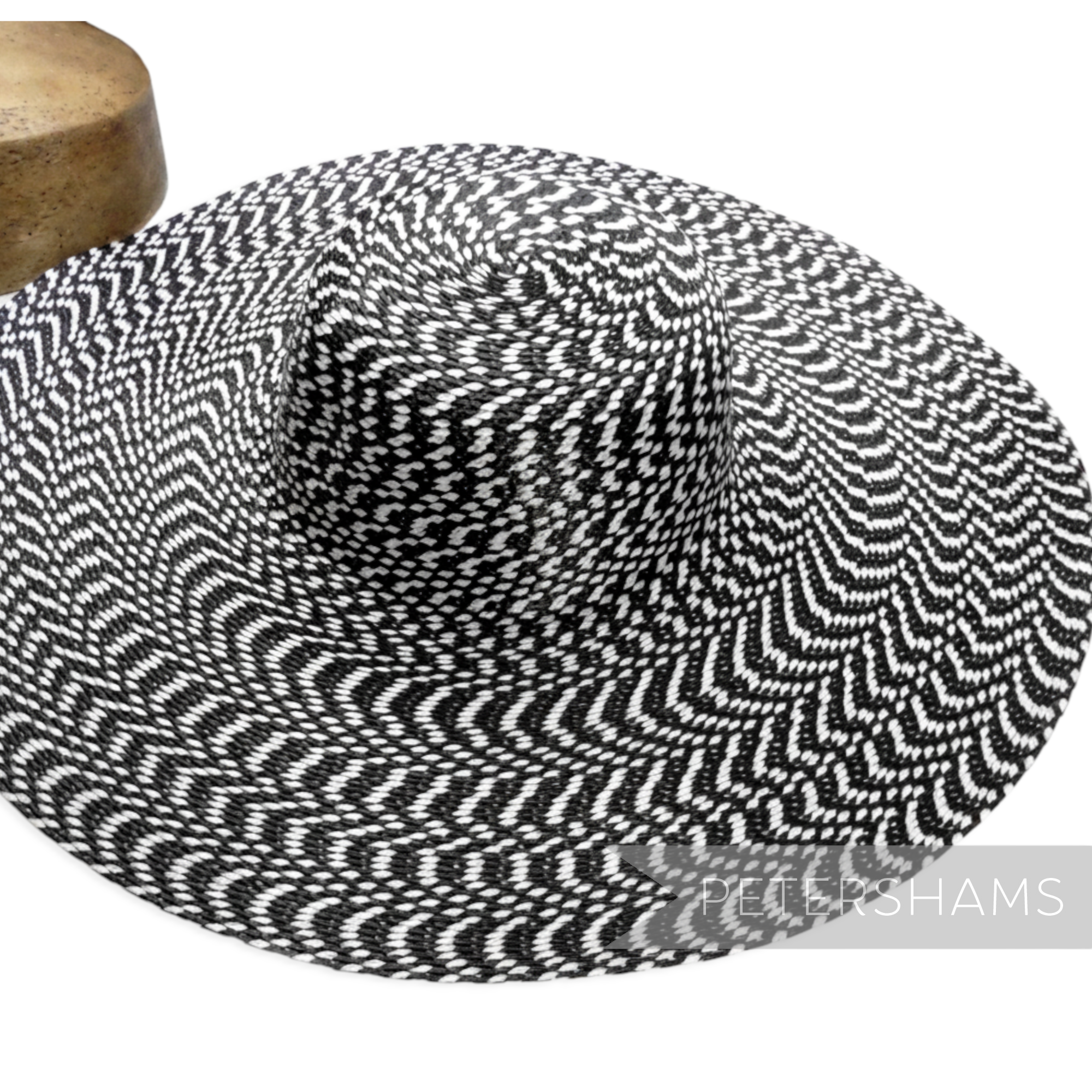 Petershams Millinery Supplies black and white polybraid capeline hat body with a hypnotic undulating brim pattern.