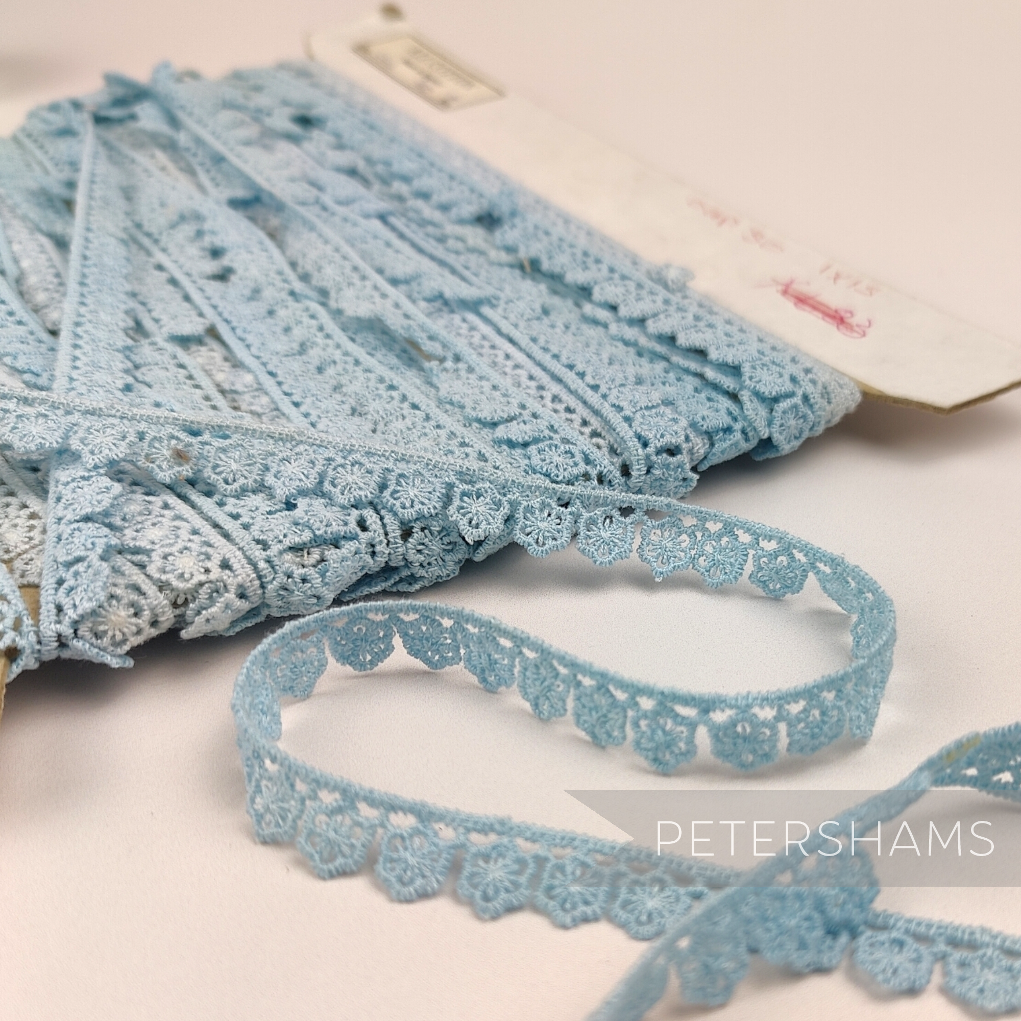 Petershams Millinery Supplies vintage 11mm light blue daisy lace trim on a card with slight dye imperfections