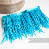 Petershams Millinery Supplies bright blue goose biot feather fringe with satin ribbon binding for millinery crafts.