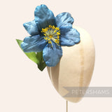 Petershams Millinery Supplies vintage dusky blue silk hibiscus flower with yellow stamens on a millinery display head