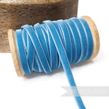 Petershams Millinery Supplies 7mm vintage blue velvet ribbon on a wooden spool for millinery and craft projects.