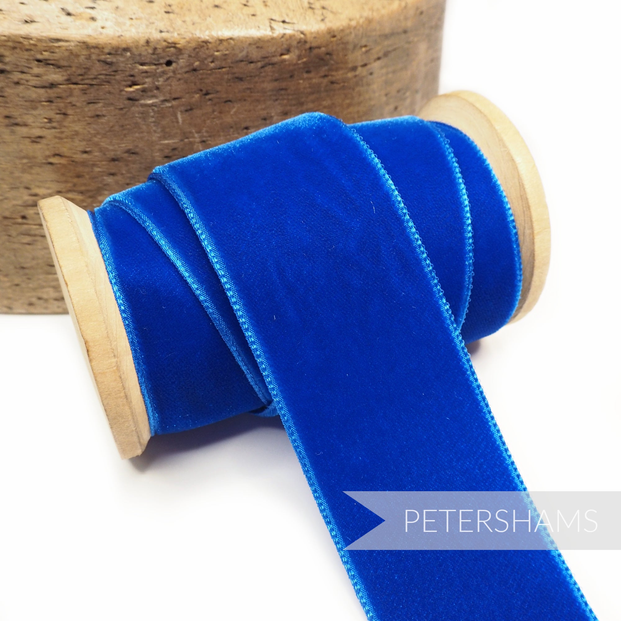 Petershams Millinery Supplies 36mm royal blue French velvet ribbon on a wooden spool for craft and millinery projects.