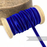Petershams Millinery Supplies 7mm royal blue vintage velvet ribbon on a wooden spool for millinery and craft projects.