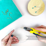 Petershams Millinery Supplies brass wire joining ferrules being crimped onto millinery wire with pliers