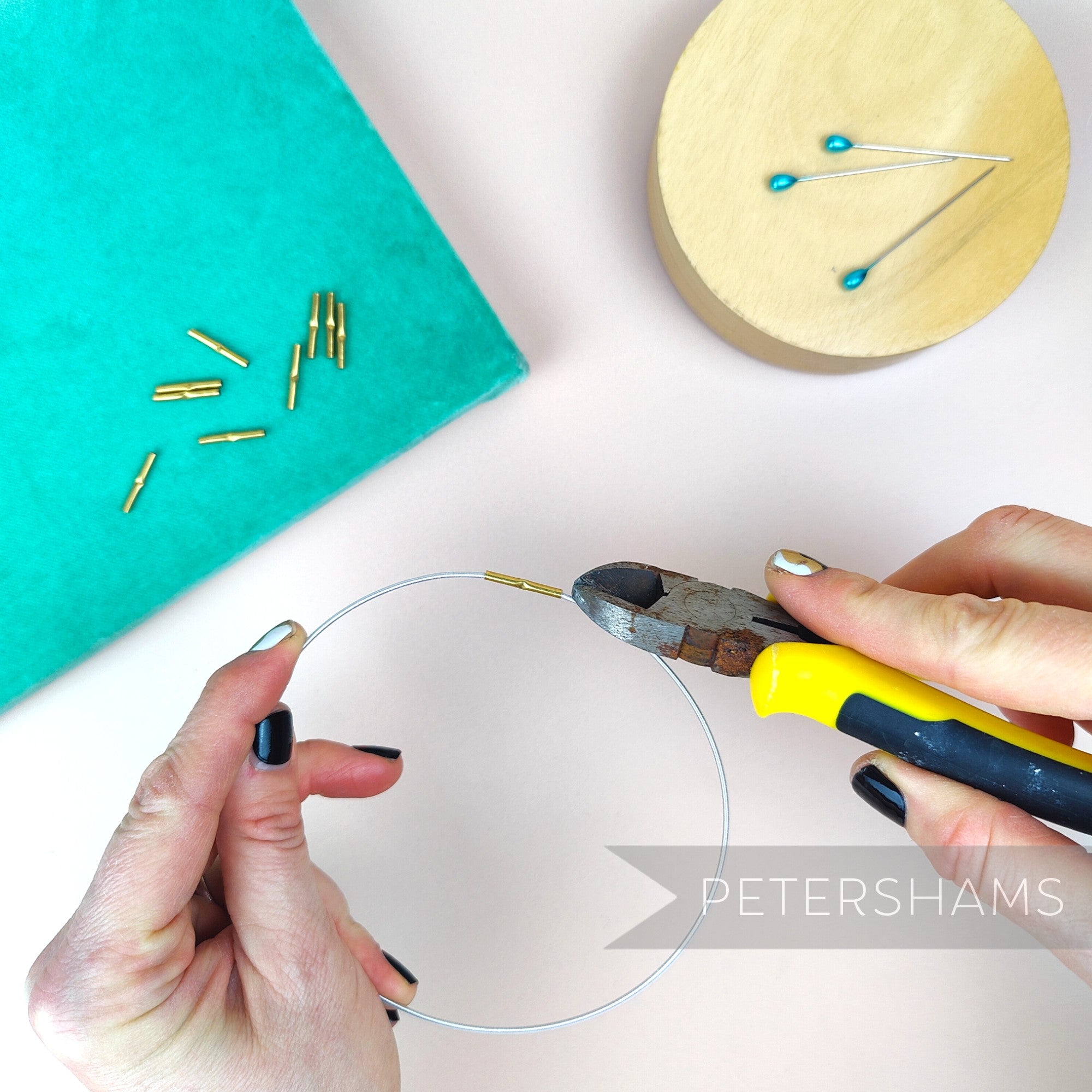 Petershams Millinery Supplies brass wire joining ferrules being crimped onto millinery wire with pliers