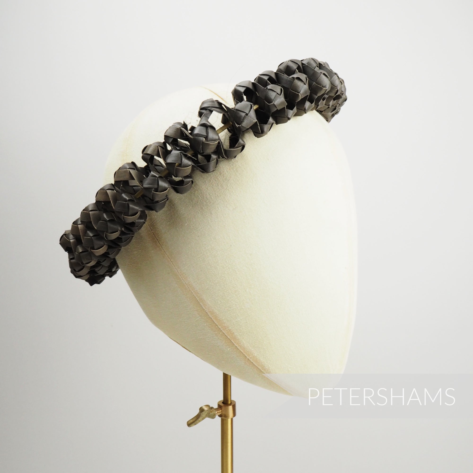 Petershams Millinery Supplies handwoven dark straw adjustable headdress frame on a mannequin head