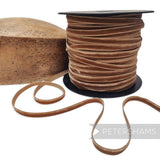 Petershams Millinery Supplies 7mm toast brown French velvet ribbon on a spool next to a wooden hat block