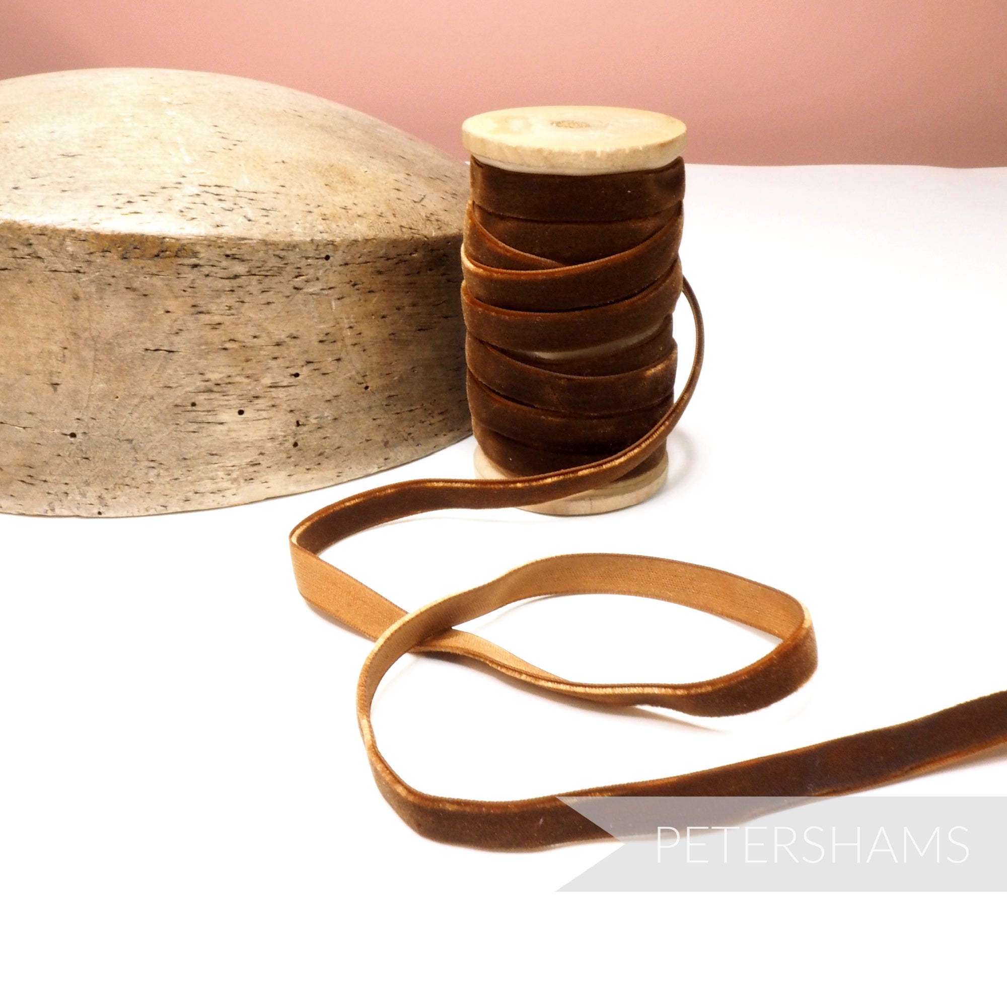 Petershams Millinery Supplies 10mm vintage brown velvet ribbon on a wooden spool next to a millinery hat block