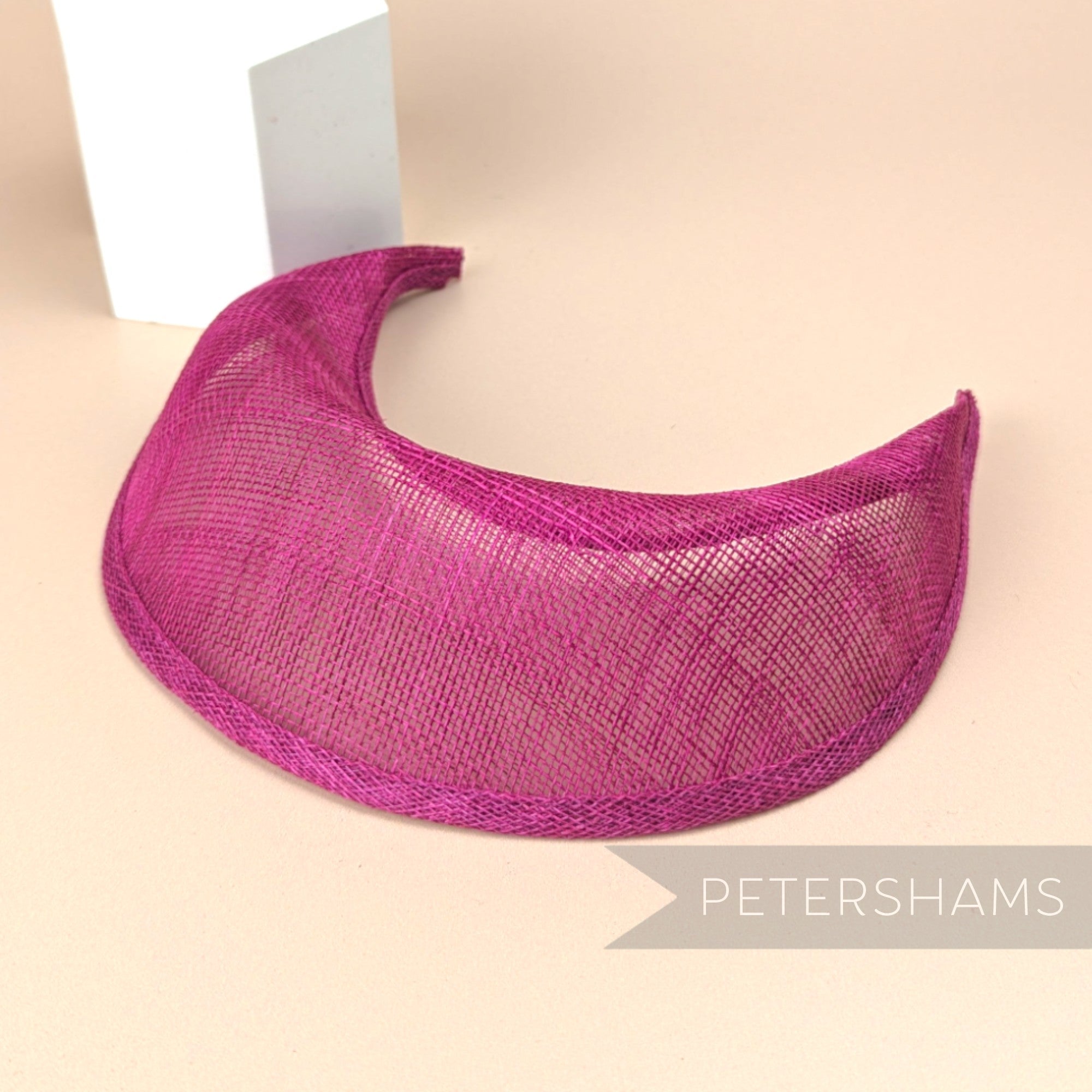 Petershams Millinery Supplies cerise sinamay halo crown fascinator hat base with a domed front and tapered ends.