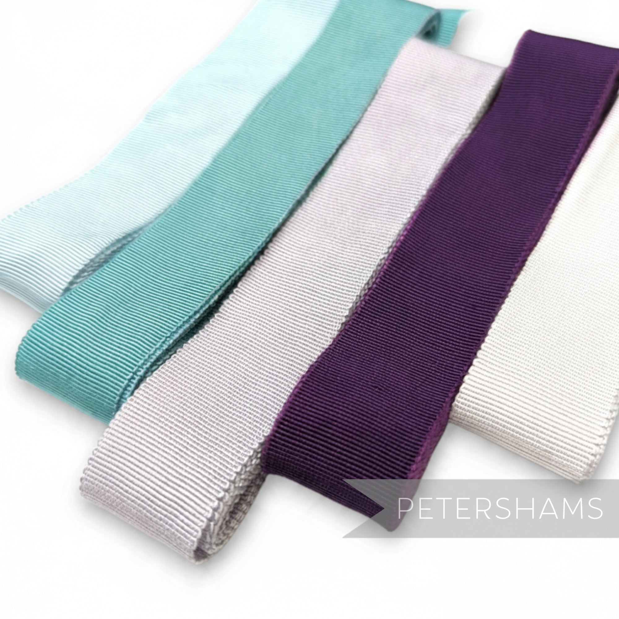 Petershams Millinery Supplies cool collection petersham ribbon assortment in blue, green, purple, and neutral tones.