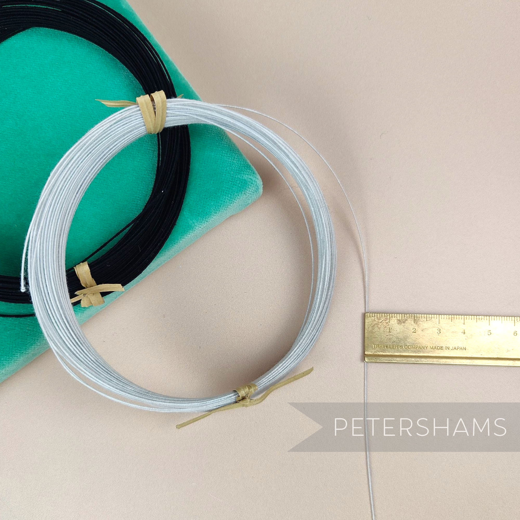 Petershams Millinery Supplies 0.4mm French cotton covered steel millinery wire in white and black coils on velvet