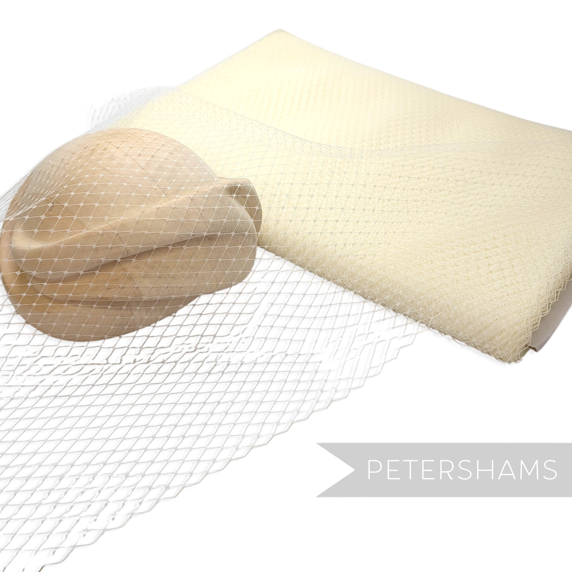 Petershams Millinery Supplies 18 inch wide cream diamond pattern birdcage veiling draped over a wooden hat block