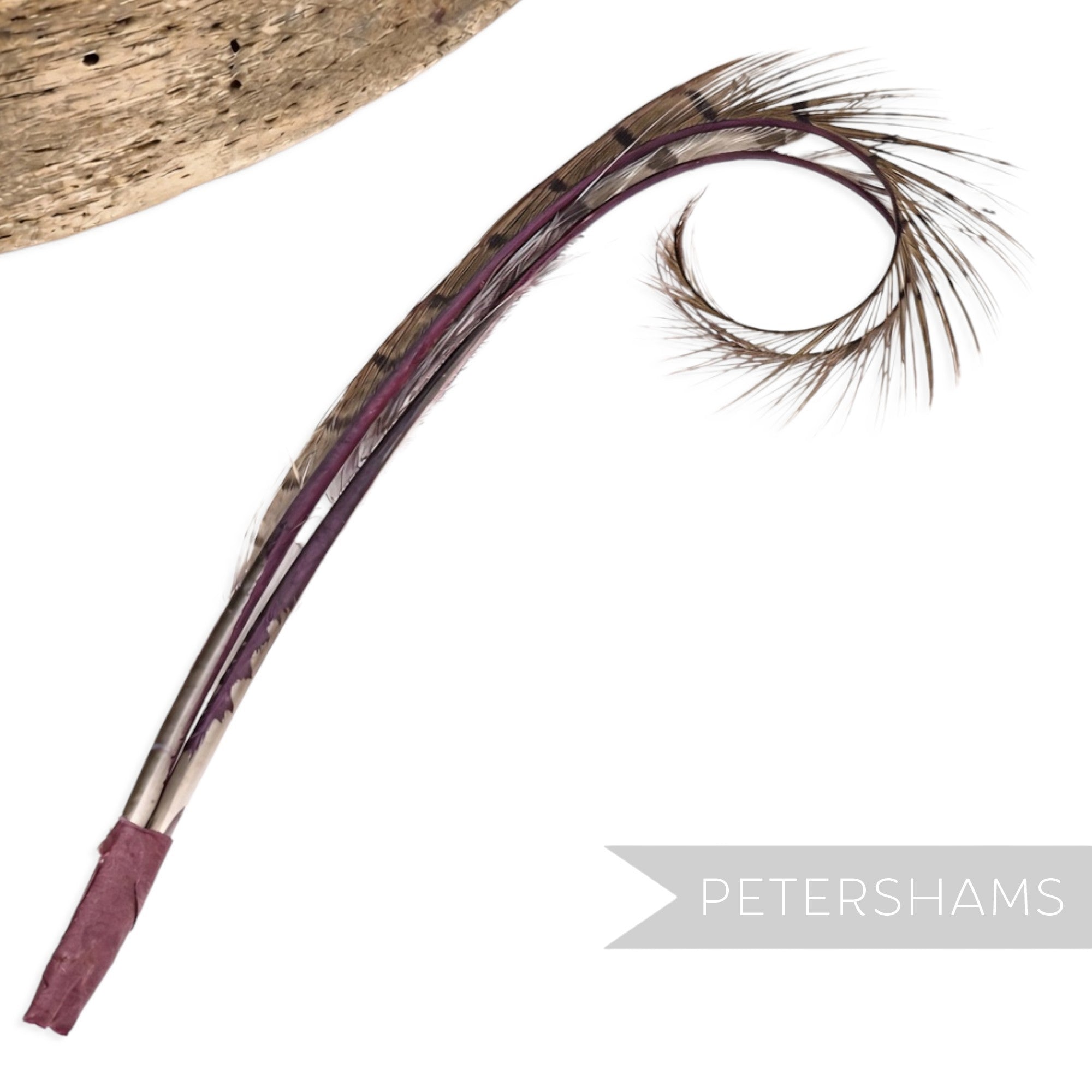 Petershams Millinery Supplies double burnt and curled pheasant feather hat mount in purple and natural tones.