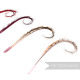 Petershams Millinery Supplies curled and burnt pheasant feather hat mounts in various dyed colours on white background