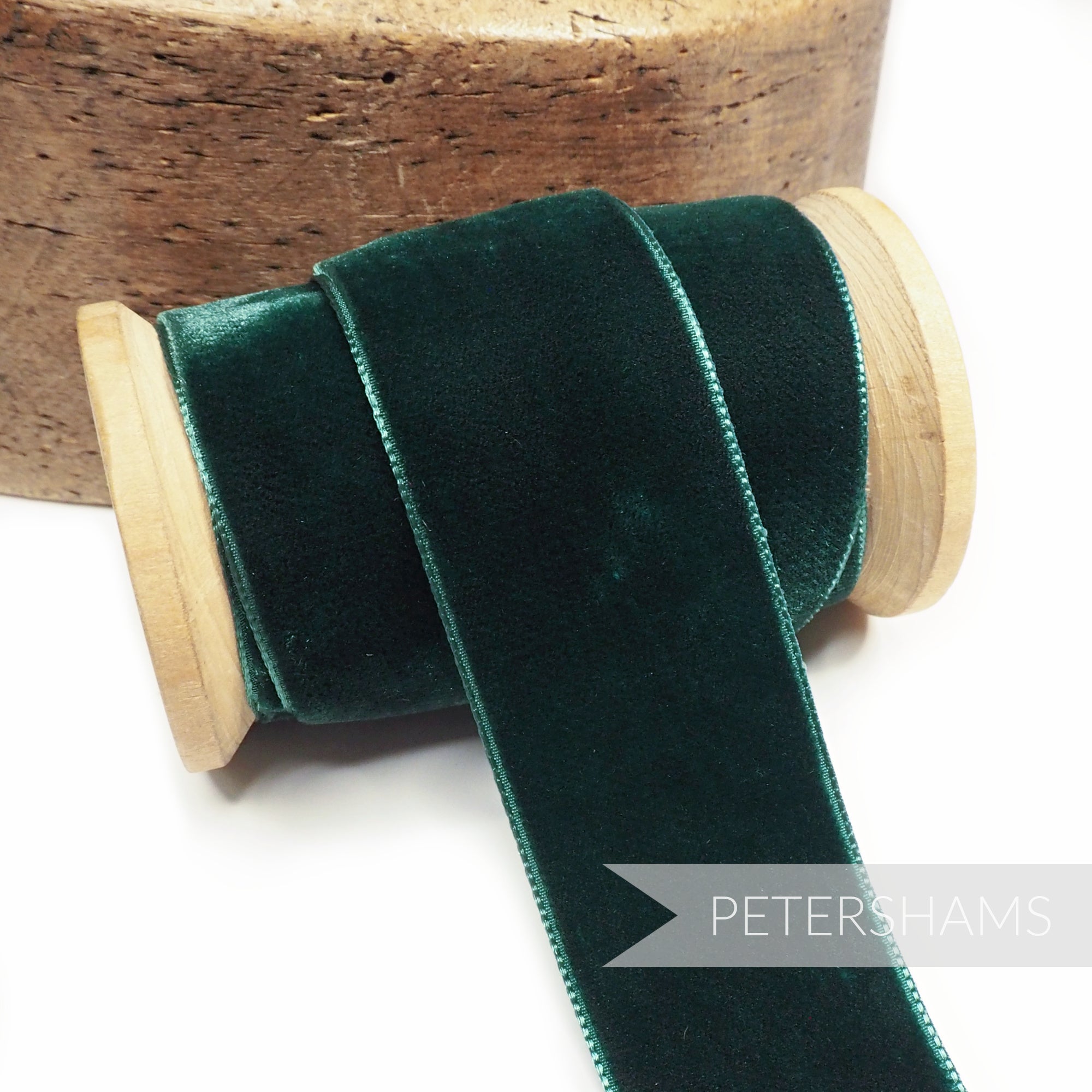Petershams Millinery Supplies 36mm bottle green French velvet ribbon on a wooden spool for millinery and craft projects.