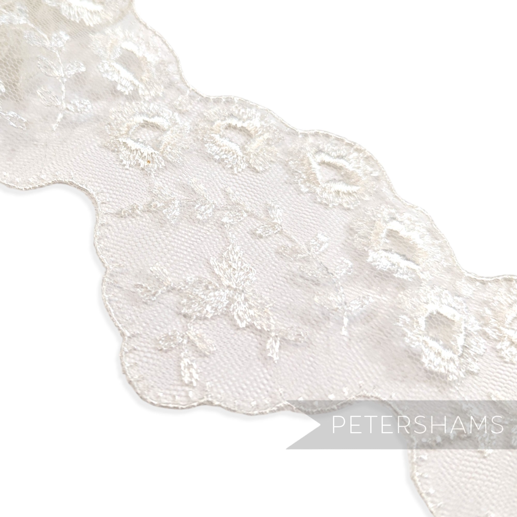 Petershams Millinery Supplies 80mm white tulle lace trim with embroidered eyelet, leaf spray, and scalloped edges.