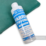 Petershams Millinery Supplies Hi-Tack fabric stiffener 250ml bottle for lace and ribbon on a green surface
