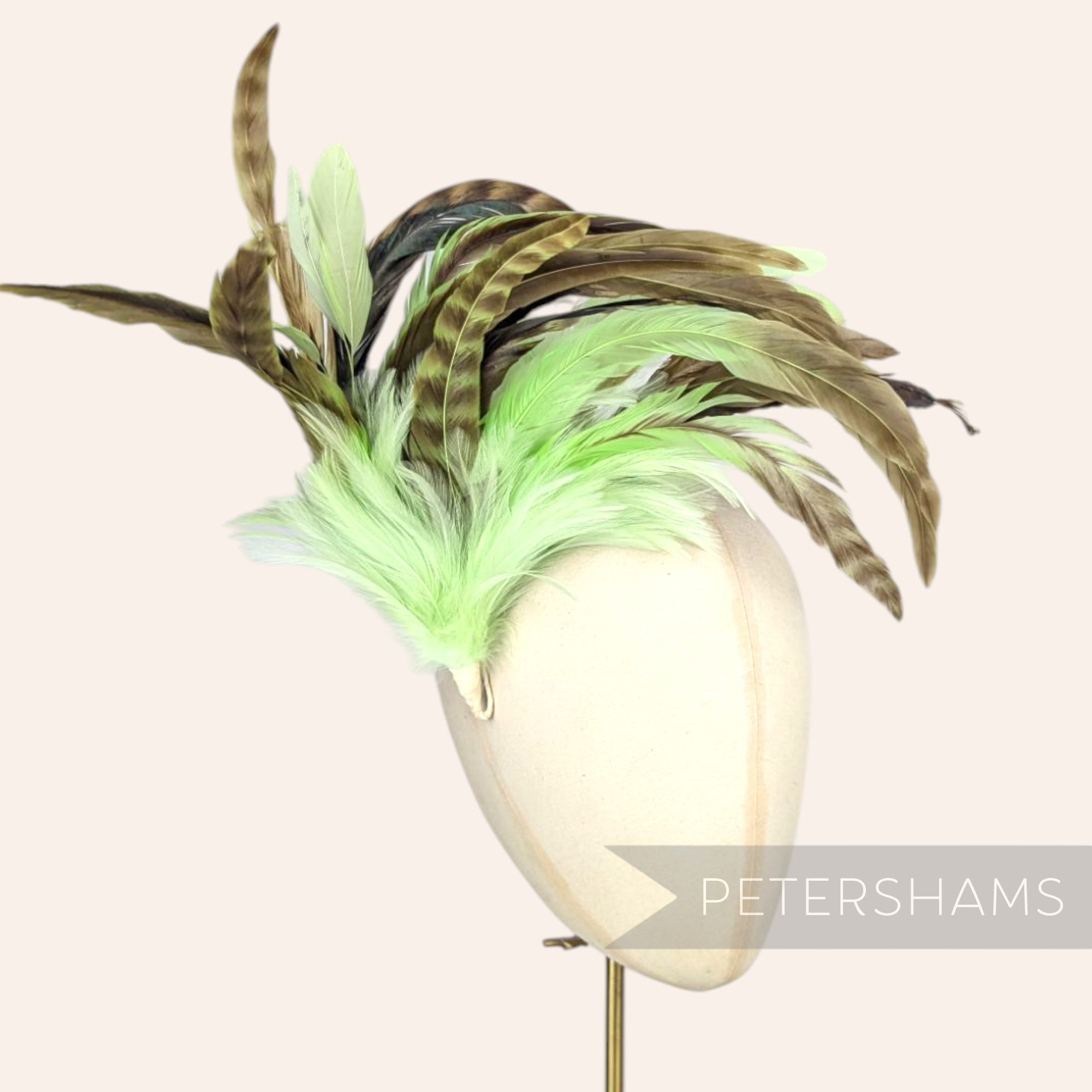 Petershams Millinery Supplies extra large feather hat mount with green and brown chinchilla pattern coque feathers.