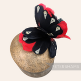 Petershams Millinery Supplies large black and red goose nagorie and french partridge feather hat mount on a block