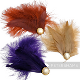 Petershams Millinery Supplies marabou and coque feather hat mounts in orange, purple, and tan with pearl cabochons.