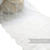 Petershams Millinery Supplies 25cm wide white sheer lace trim featuring a floral scale pattern and scalloped edges.