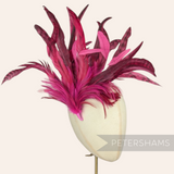 Petershams Millinery Supplies extra large fuchsia pink coque and hackle feather hat mount on a millinery head block.