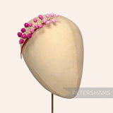 Petershams Millinery Supplies Giselle silk rosebud hat mount in shades of pink on a millinery head block