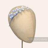 Petershams Millinery Supplies Giselle mini silk wired rosebud hat mount in light blue on a millinery head form