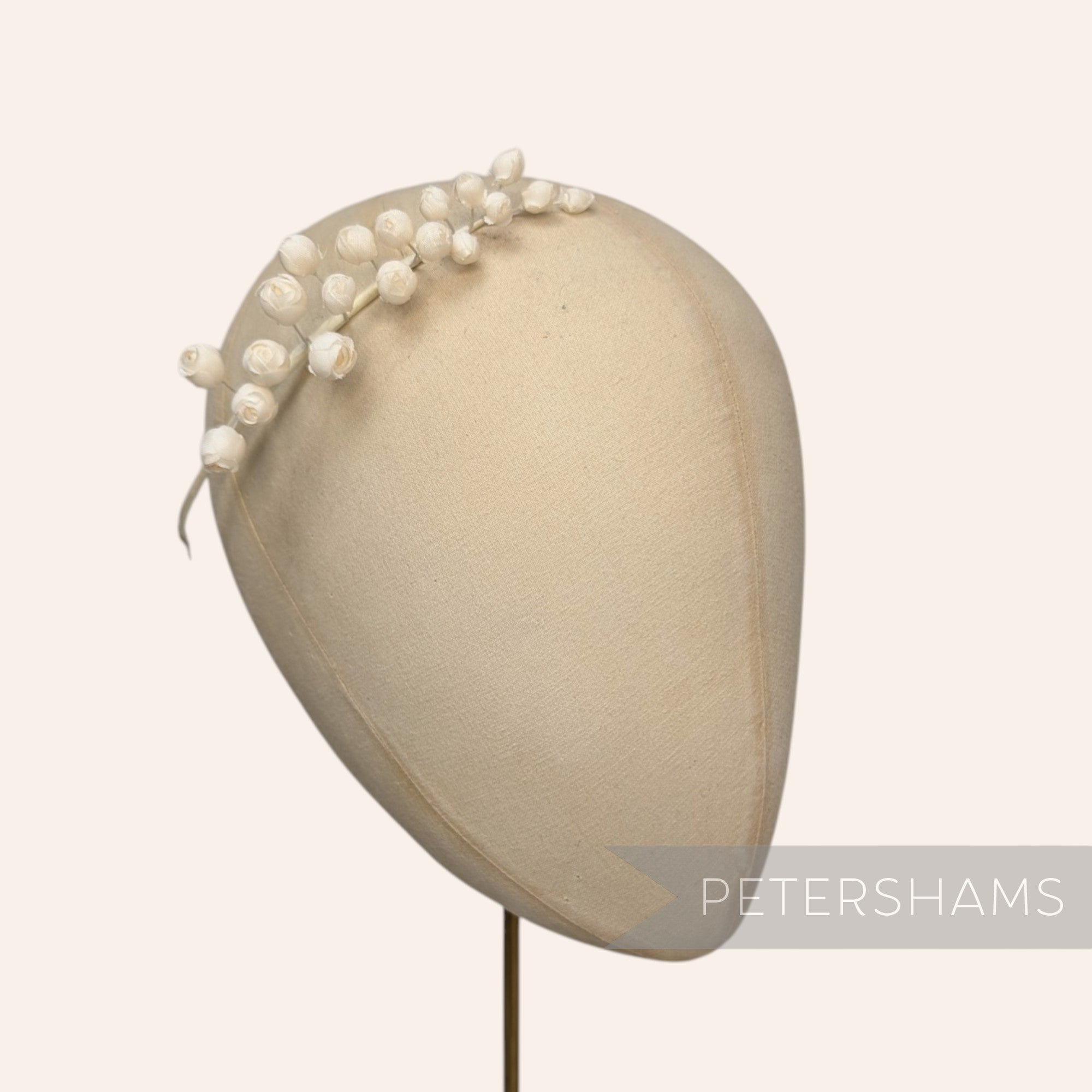 Petershams Millinery Supplies Giselle mini silk wired rosebud hat mount in white on a mannequin head